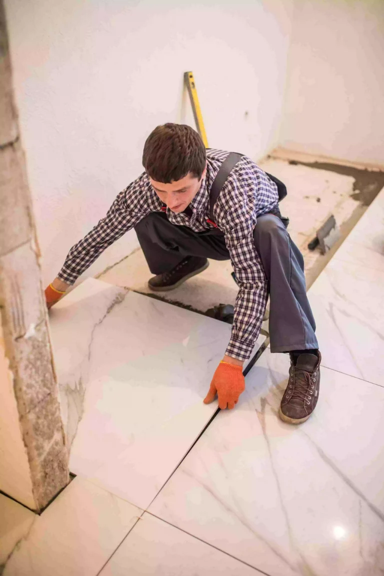 construction worker tiler is tiling ceramic tile floor adhesive laying ceramic tiles min 11zon